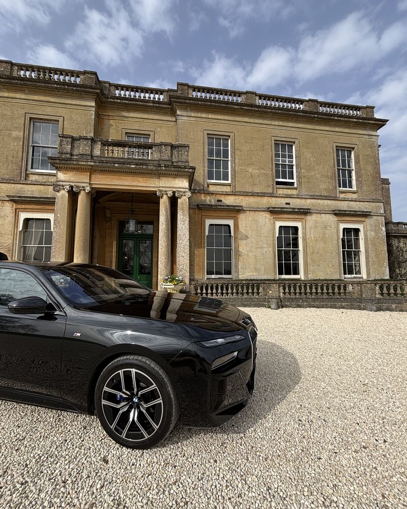Chauffeur car waiting outside a Georgian Bath-stone house